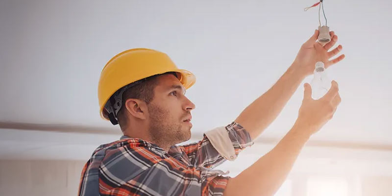 Electrician changing a light fitting